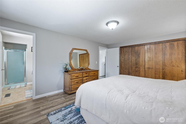 2505 Angela St SE, Lacey, WA 98503 - bedroom featuring wood finished floors, a textured ceiling, and baseboards