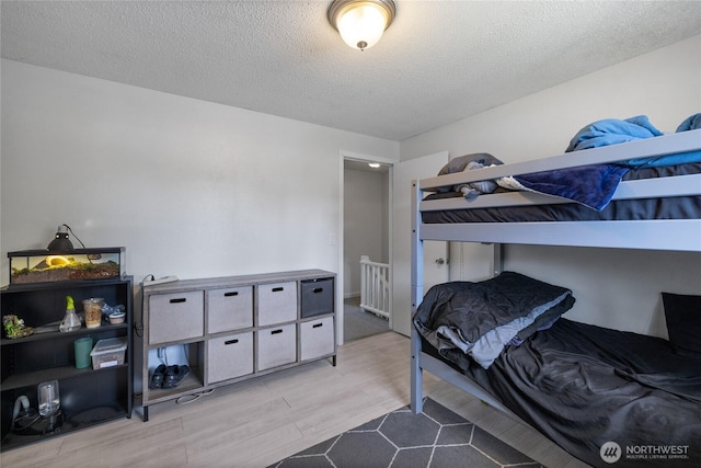 2505 Angela St SE, Lacey, WA 98503 - bedroom with wood finished floors and a textured ceiling