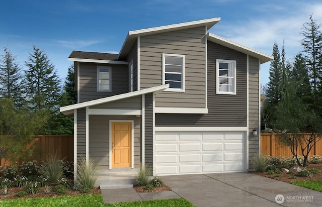 modern home featuring fence, an attached garage, and concrete driveway