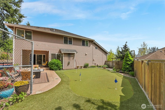 1401 241st St SE, Bothell, WA 98021 - back of property with an area to practice putting, a fenced backyard, and a patio area