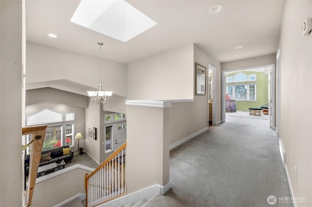 1401 241st St SE, Bothell, WA 98021 - hall featuring baseboards, a chandelier, carpet, a skylight, and an upstairs landing