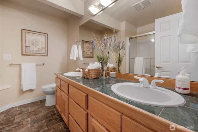 1401 241st St SE, Bothell, WA 98021 - bathroom with a shower stall, baseboards, double vanity, toilet, and stone finish floors