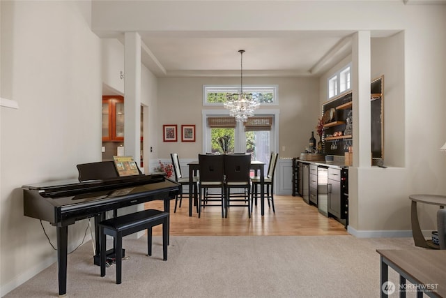 1401 241st St SE, Bothell, WA 98021 - dining room with light carpet, a chandelier, baseboards, and a bar