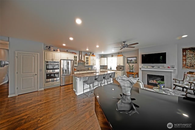 5042 Mariner St, Gig Harbor, WA 98332 - dining space featuring a ceiling fan, dark wood finished floors, recessed lighting, a glass covered fireplace, and baseboards