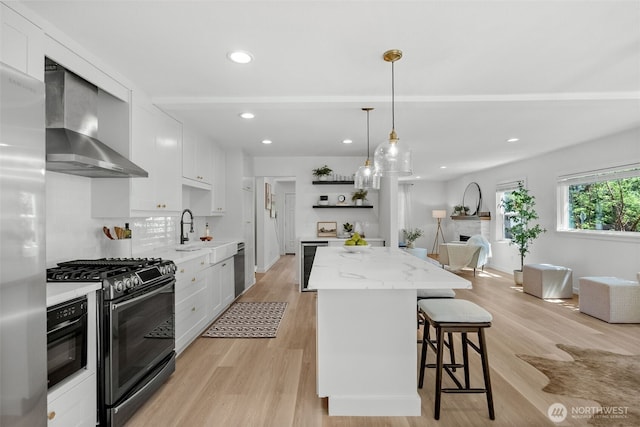 354 Summit Ave, Fircrest, WA 98466 - kitchen with wall chimney exhaust hood, appliances with stainless steel finishes, open shelves, a center island, and a kitchen bar