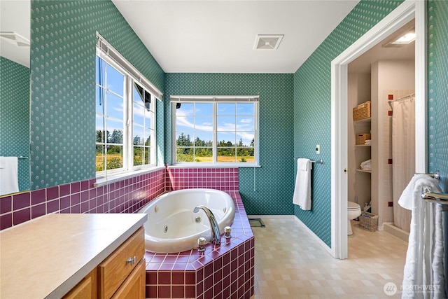 2470 Lee Way, Bellingham, WA 98226 - bathroom with wallpapered walls, a jetted tub, toilet, vanity, and baseboards