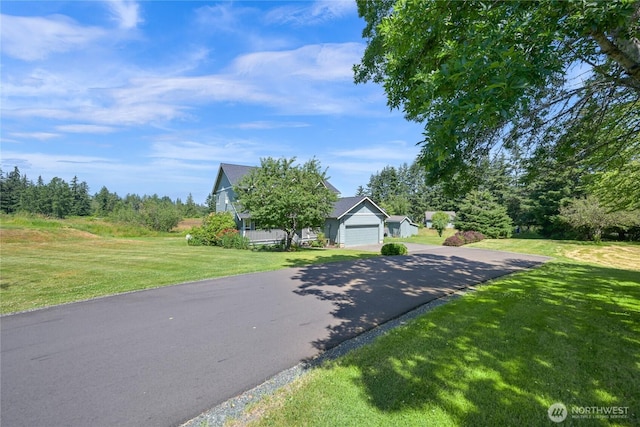 2470 Lee Way, Bellingham, WA 98226 - obstructed view of property with a garage, a front yard, and asphalt driveway