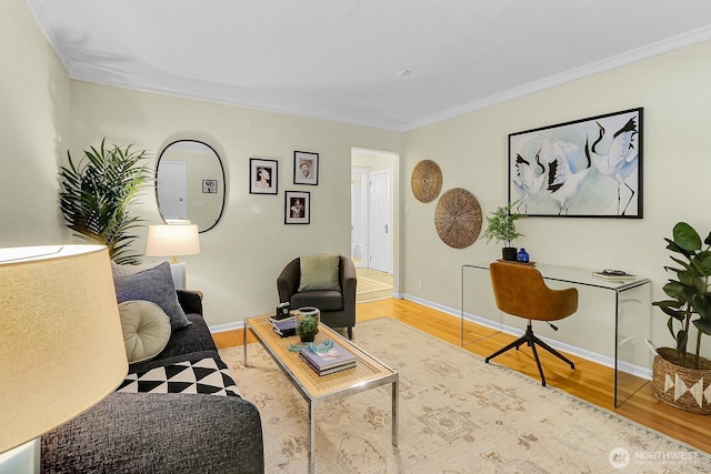 516 E Thomas St Unit 105, Seattle, WA 98102 - living room with wood finished floors, a desk, ornamental molding, and baseboards