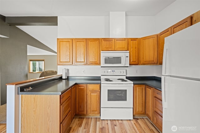 412 Algona Blvd S, Algona, WA 98001 - kitchen with white appliances, a peninsula, dark countertops, light wood-type flooring, and brown cabinetry