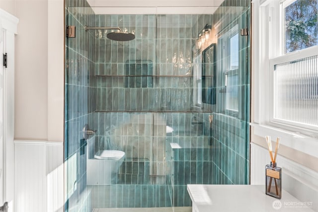 515 4th Ave SW, Puyallup, WA 98371 - bathroom featuring a shower stall, toilet, and wainscoting
