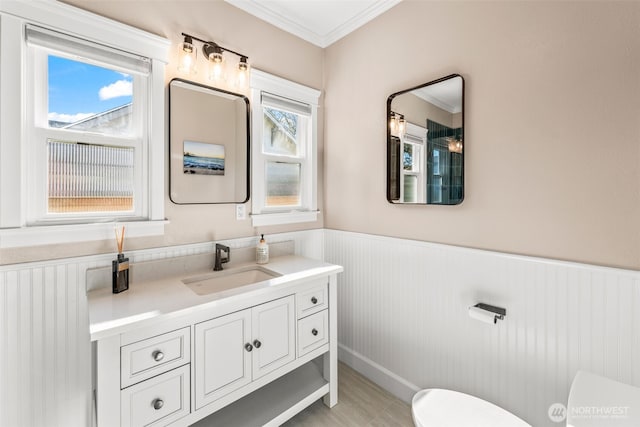 515 4th Ave SW, Puyallup, WA 98371 - bathroom with toilet, wainscoting, crown molding, and vanity