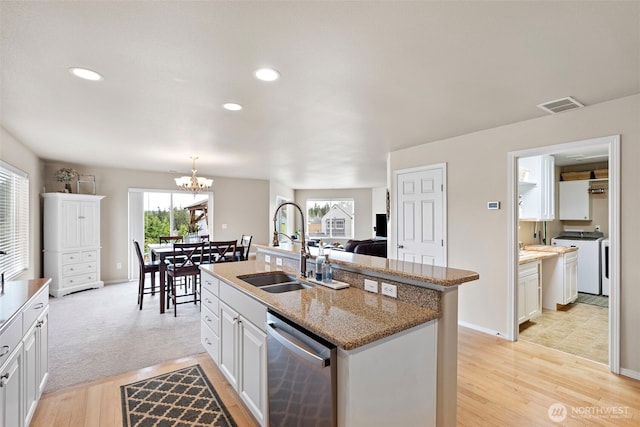 21032 Nordby Dr NW, Poulsbo, WA 98370 - kitchen featuring dishwasher, a sink, separate washer and dryer, a chandelier, and plenty of natural light