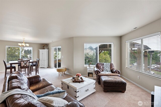 21032 Nordby Dr NW, Poulsbo, WA 98370 - living area with a chandelier, light carpet, and healthy amount of natural light
