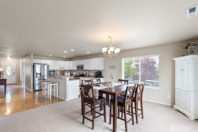 21032 Nordby Dr NW, Poulsbo, WA 98370 - dining area with a chandelier, light colored carpet, baseboards, and recessed lighting