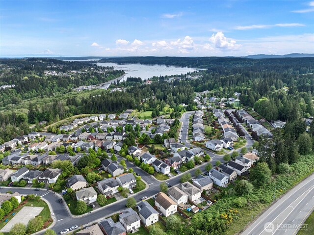 21032 Nordby Dr NW, Poulsbo, WA 98370 - aerial view of property and surrounding area with a forest, a large body of water, and nearby suburban area