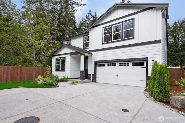2406 Hyde Ct NE Unit 9, Olympia, WA 98506 - view of front of house with board and batten siding, an attached garage, fence, and concrete driveway
