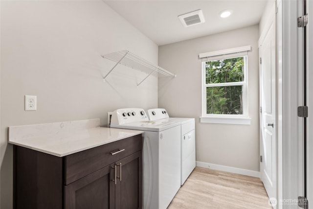 2406 Hyde Ct NE Unit 9, Olympia, WA 98506 - laundry area with baseboards, light wood-style flooring, independent washer and dryer, and cabinet space