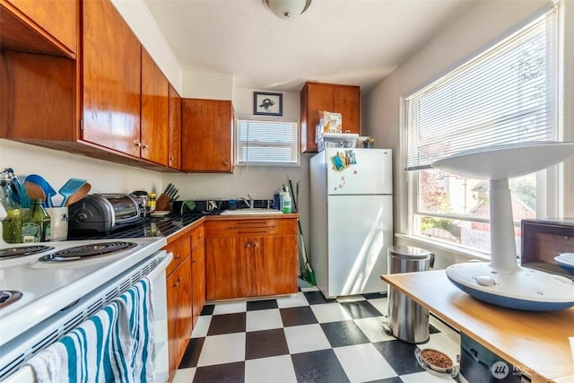2630 58th Ave SW Unit 1-4, Seattle, WA 98116 - kitchen with white appliances, dark flooring, a sink, and brown cabinetry