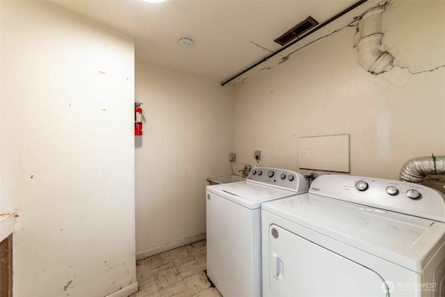 2630 58th Ave SW Unit 1-4, Seattle, WA 98116 - washroom with washing machine and clothes dryer, light floors, and baseboards