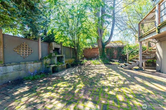 2630 58th Ave SW Unit 1-4, Seattle, WA 98116 - view of yard featuring a patio, stairs, and fence