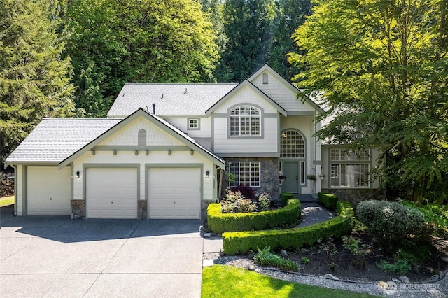 6336 286th Pl NE, Carnation, WA 98014 - view of front of property featuring stone siding, an attached garage, driveway, and roof with shingles