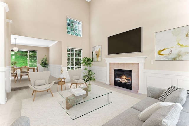 6336 286th Pl NE, Carnation, WA 98014 - living room with a high ceiling, a decorative wall, healthy amount of natural light, a tile fireplace, and wainscoting