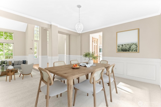 6336 286th Pl NE, Carnation, WA 98014 - dining space featuring light colored carpet, a wainscoted wall, ornamental molding, a chandelier, and a decorative wall