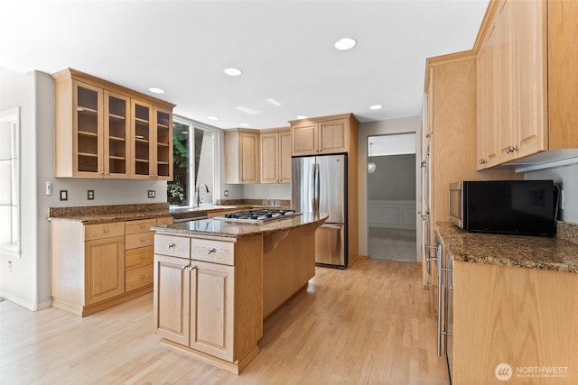 6336 286th Pl NE, Carnation, WA 98014 - kitchen featuring stainless steel appliances, light wood finished floors, dark stone counters, and recessed lighting
