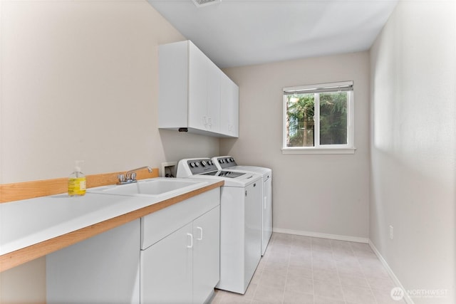 6336 286th Pl NE, Carnation, WA 98014 - clothes washing area featuring cabinet space, washing machine and dryer, baseboards, and light tile patterned floors