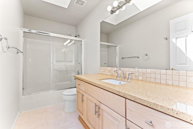 6336 286th Pl NE, Carnation, WA 98014 - bathroom featuring toilet, tasteful backsplash, vanity, bath / shower combo with glass door, and tile patterned flooring
