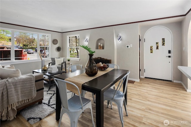 1602 NW 83rd St, Seattle, WA 98117 - dining space with healthy amount of natural light, light wood-style flooring, baseboards, and ornamental molding