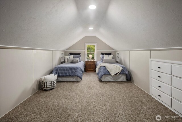 1602 NW 83rd St, Seattle, WA 98117 - bedroom with lofted ceiling, carpet flooring, a textured ceiling, and a decorative wall
