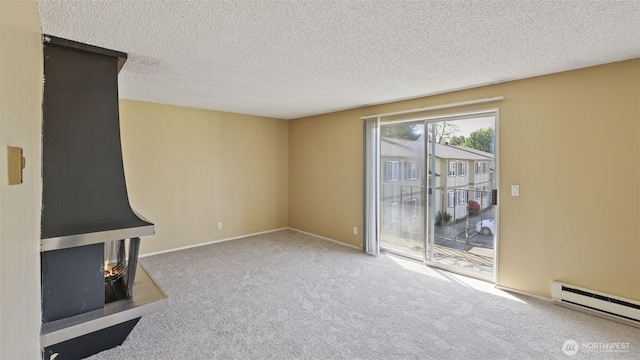 unfurnished living room with a baseboard radiator, carpet floors, a textured ceiling, and baseboards