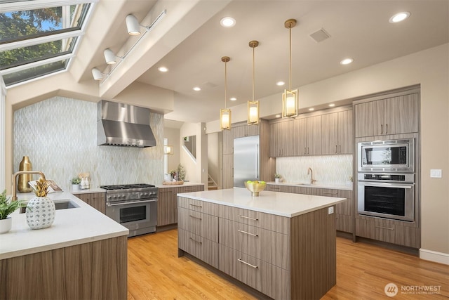5874 169th Ave SE, Bellevue, WA 98006 - kitchen featuring built in appliances, wall chimney range hood, modern cabinets, tasteful backsplash, and light countertops