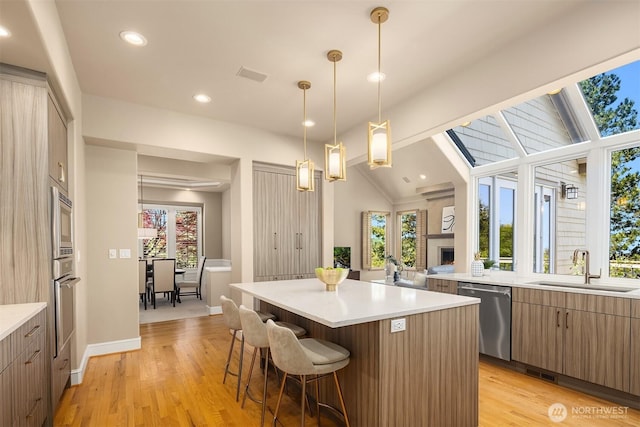5874 169th Ave SE, Bellevue, WA 98006 - kitchen featuring appliances with stainless steel finishes, a sink, a kitchen island, recessed lighting, and light countertops