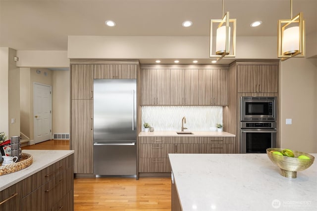 5874 169th Ave SE, Bellevue, WA 98006 - kitchen with built in appliances, a sink, light wood-type flooring, modern cabinets, and recessed lighting