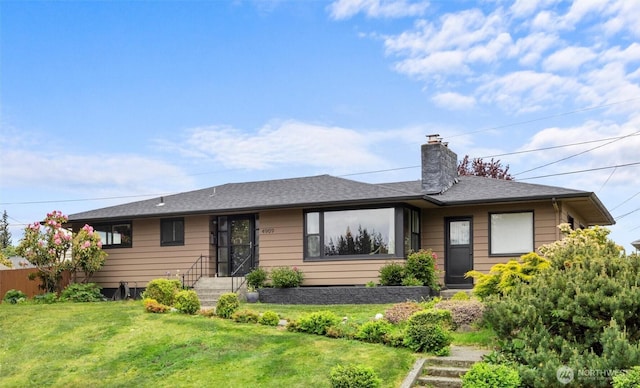 single story home featuring a chimney, a front lawn, and roof with shingles