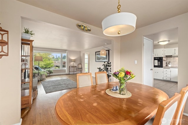 dining space featuring light wood-type flooring