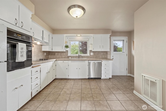 kitchen featuring black appliances, tasteful backsplash, plenty of natural light, and white cabinets