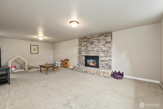 carpeted living area featuring a fireplace and baseboards