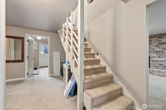 stairway featuring carpet flooring and baseboards