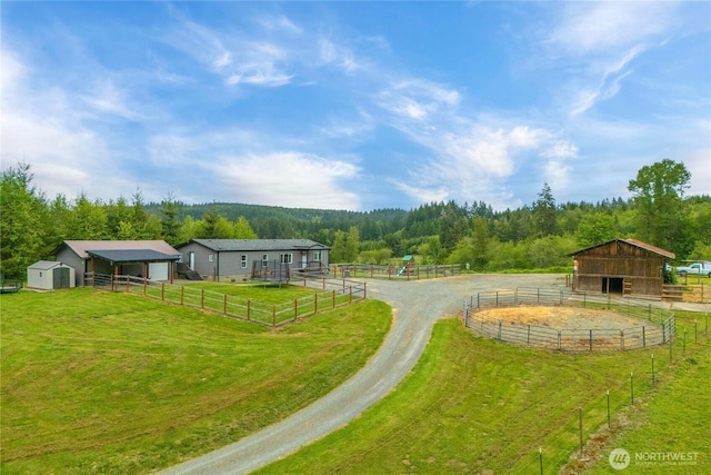 882 Independence Rd, Rochester, WA 98579 - view of yard featuring an exterior structure, an outdoor structure, a view of trees, a view of rural / pastoral area, and driveway