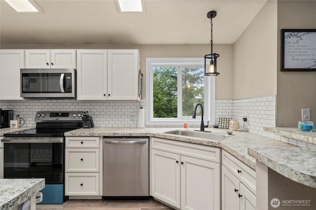 882 Independence Rd, Rochester, WA 98579 - kitchen with appliances with stainless steel finishes, a sink, white cabinets, and light countertops