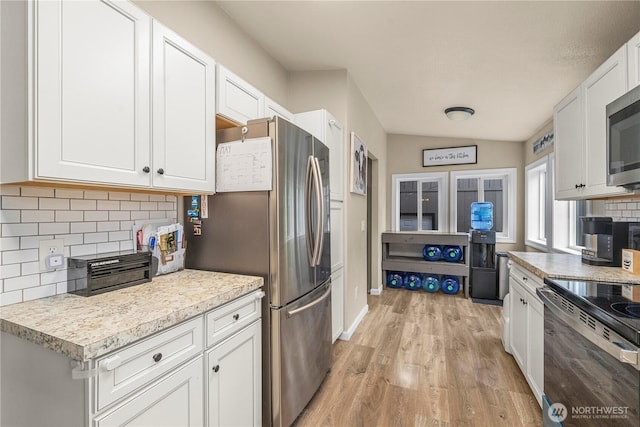882 Independence Rd, Rochester, WA 98579 - kitchen featuring appliances with stainless steel finishes, backsplash, white cabinets, light wood finished floors, and light countertops
