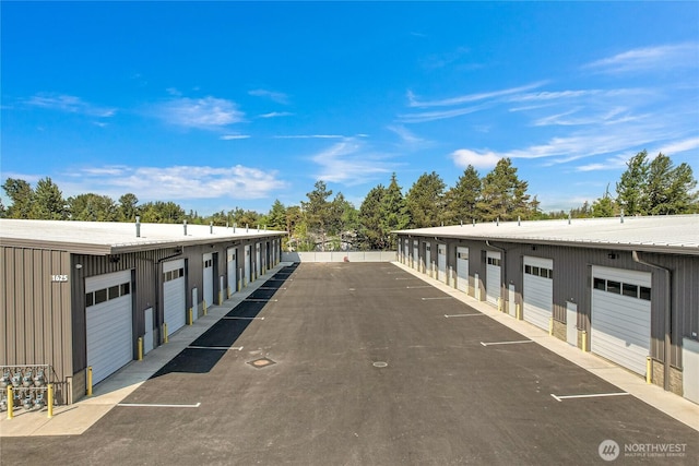 view of road featuring community garages