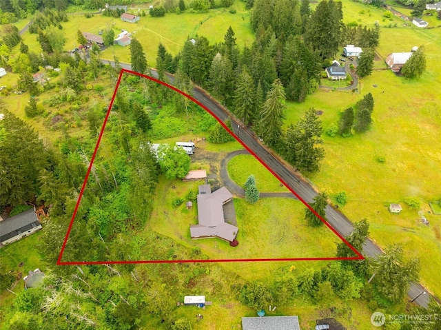 aerial view of property and surrounding area featuring property parcel outlined