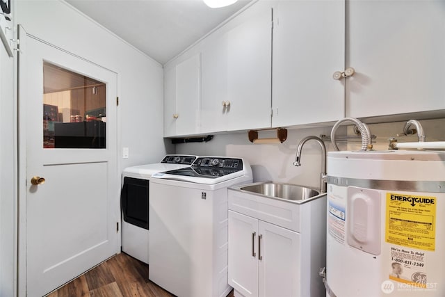 clothes washing area featuring electric water heater, cabinet space, dark wood finished floors, and washer and dryer
