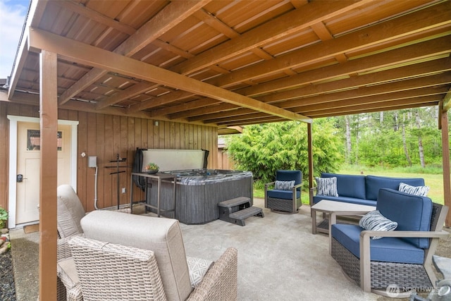 view of patio featuring a hot tub and outdoor lounge area