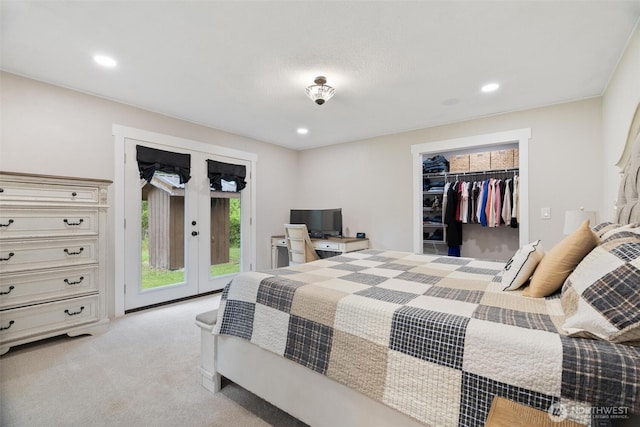 bedroom with access to outside, french doors, light carpet, recessed lighting, and a walk in closet