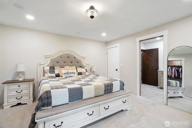 carpeted bedroom with a closet and recessed lighting